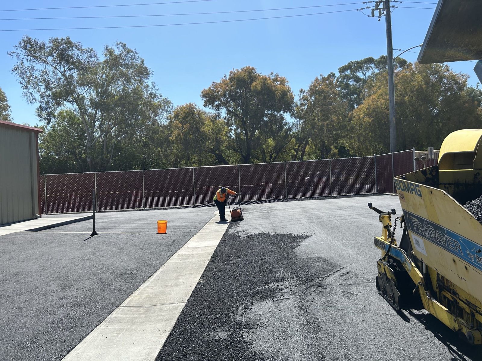 Crew paving a school playground surface