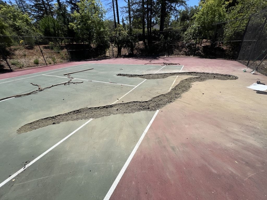 Cracked, worn asphalt lot before repaving